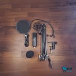 Condenser mic on desk stand for podcast recording.